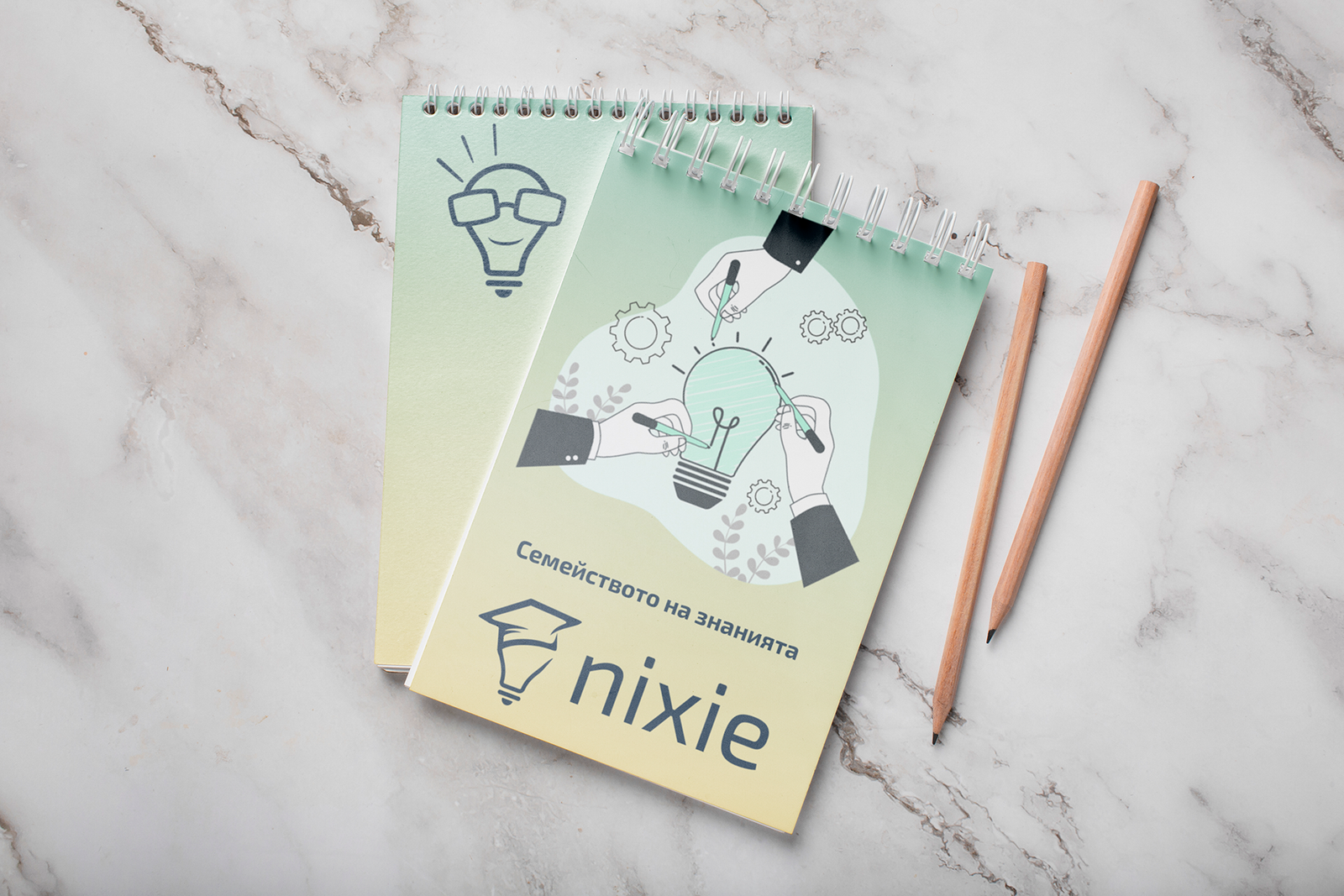 Две брандирани тетрадки на NIXIE с образователни илюстрации